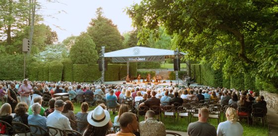An outdoor concert being performed in the Open Air Theatre at Longwood Gardens.